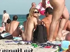 Naomi1 handjob a young guy on a public beach